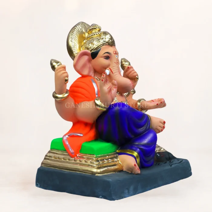 eco-friendly Ganesha idol made from light grey Shadu Mati clay, featuring an intricately carved turban and detailed clothing patterns.
