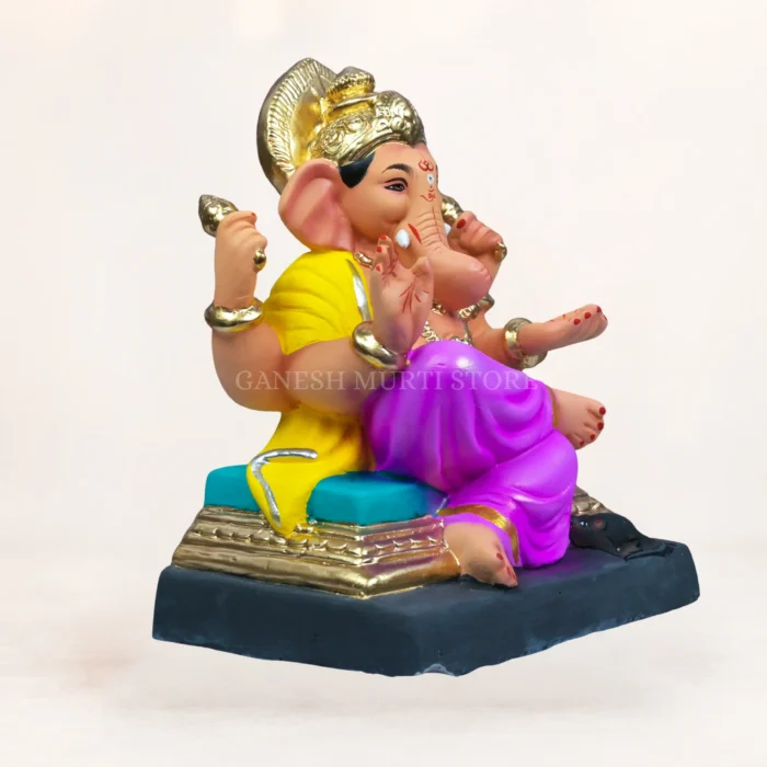 Avighna eco-friendly Ganesha idol handcrafted from clay, wearing a blue and gold Maharashtrian turban with a pink dhoti.