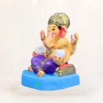 Biodegradable clay Ganpati murti with hand-painted non-toxic colors and Om symbol tilak, water-soluble for home visarjan.