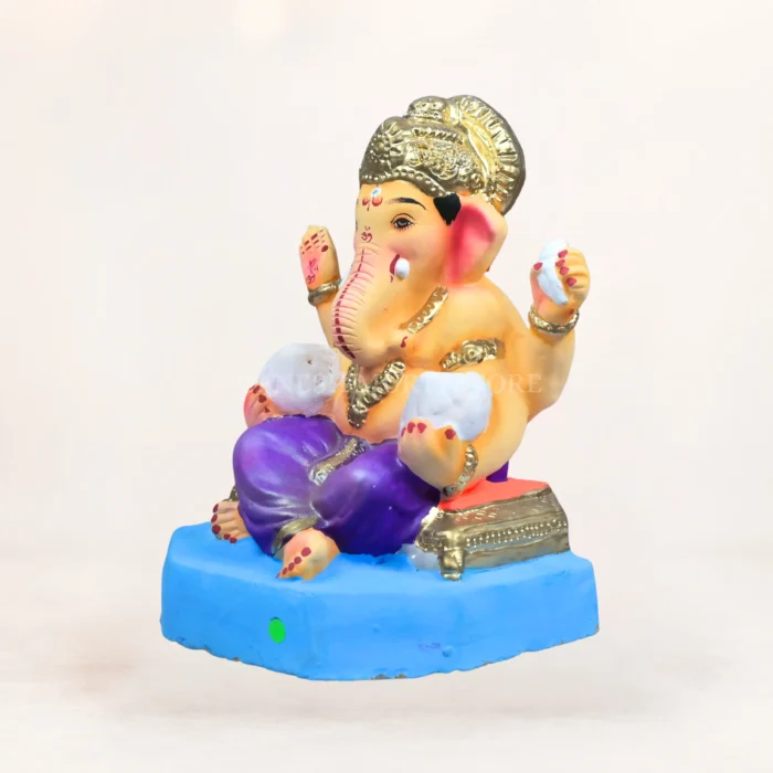 Biodegradable clay Ganpati murti with hand-painted non-toxic colors and Om symbol tilak, water-soluble for home visarjan.
