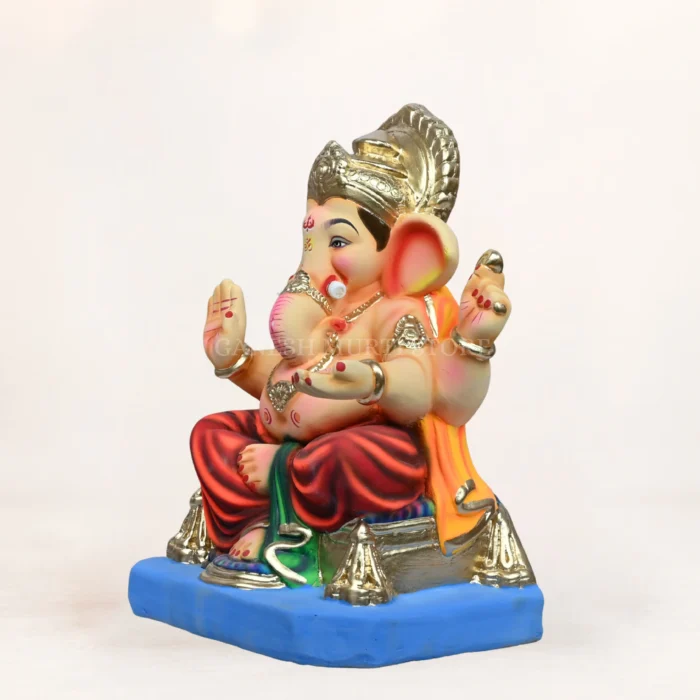 Side angle of Philips Orange Dhoti 15 Inch Eco Friendly Ganpati Murti handcrafted with natural clay.