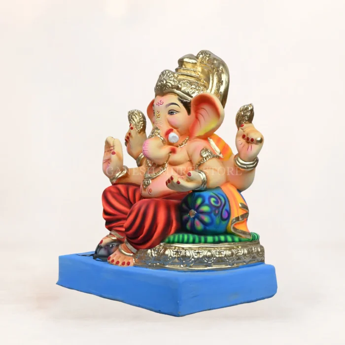 Eco-friendly clay Ganesh idol undergoing home immersion process in a bucket of water.