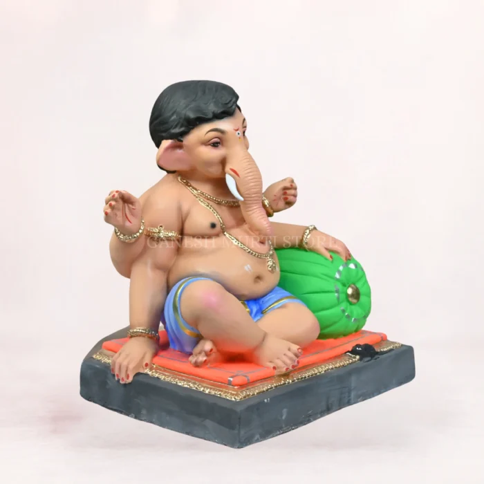 Side angle view of 18 Inch Aasan Load Eco Friendly Ganpati Idol in Delhi showing Shadu Mati Clay and Blue Dhoti details