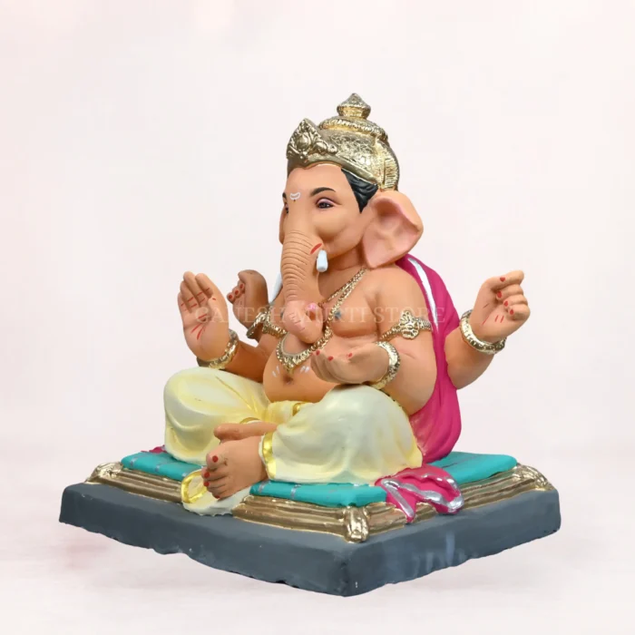 Front side angle view of handcrafted Gattu Aasan Yellow Dhoti 20 Inch Eco Friendly Ganpati Idol made from natural Shadu Mati clay.